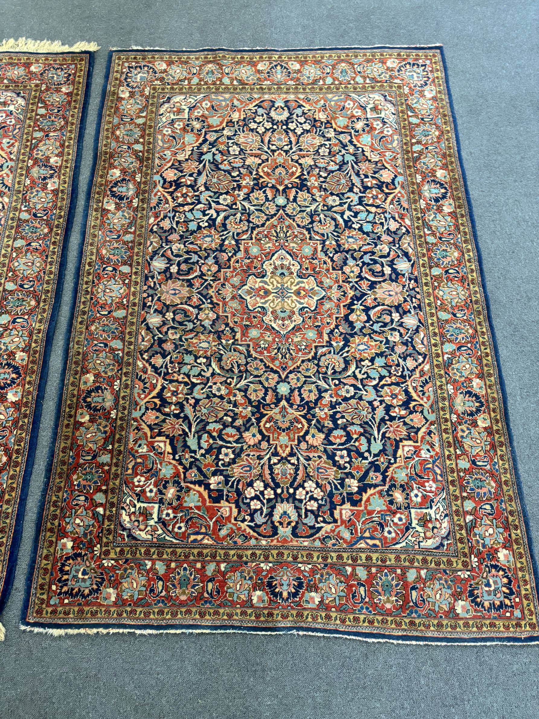 A pair of Kashan blue ground rugs, 216 x 139cm